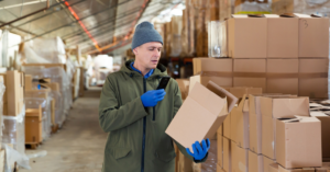 person scanning a box in a warehouse