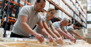 (warehouse staff sorting through goods)