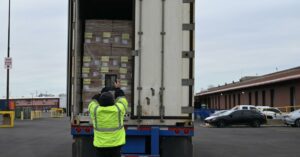 warehouse worker scanning items in a trailer