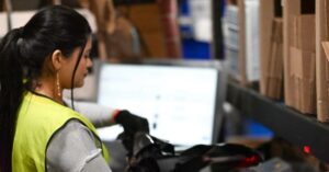 woman scanning products in a warehouse