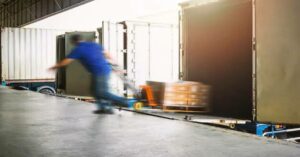 Man pulling a pallet out of a truck